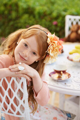 Girl, child and tea party with happiness in garden with portrait for birthday, celebration and...