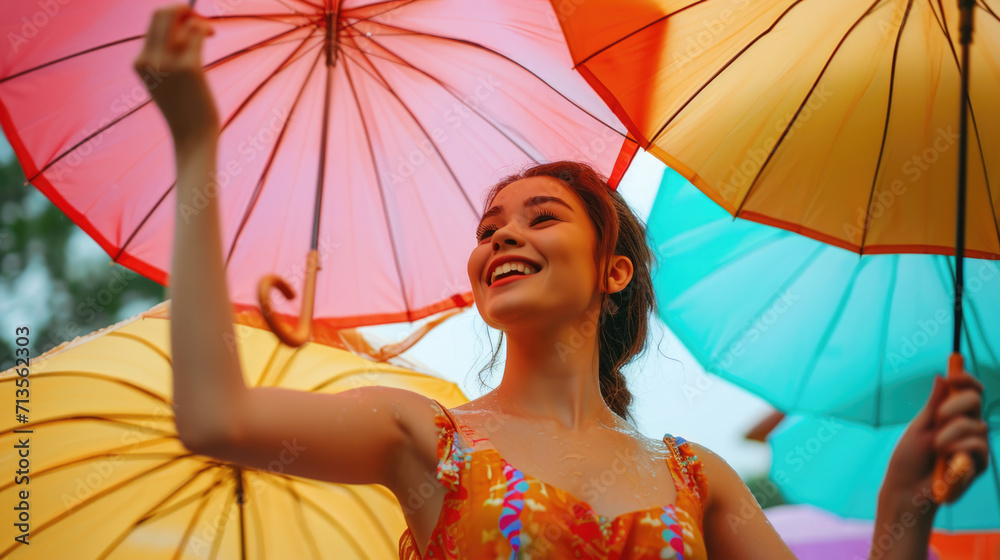 Poster a woman is seen holding a bunch of colorful umbrellas. this versatile image can be used to depict pr