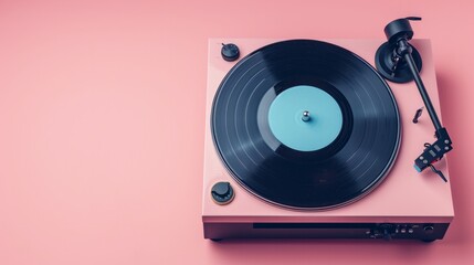 Record player with vinyl disk on pink background