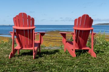 Red chairs at Rocky Harbor in Gros Morne National Park, a Canadian national park and World Heritage...