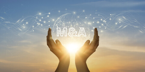 M&A. Man Holding Global Network and Connecting Data of Mergers & Acquisitions with Business on the...