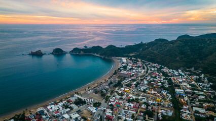 Fototapeta premium Barra de Navidad Aerial of Jalisco town beach resort destination in Mexico drone fly at sunset scenic seascape