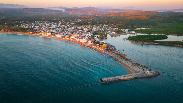 Barra de Navidad Aerial of Jalisco Mexico resort beach town with pacific coastline ocean view at sunset and lake lagoon