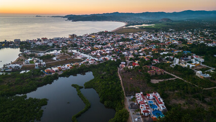 Barra de Navidad Aerial of Jalisco town beach resort destination in Mexico drone fly at sunset scenic seascape