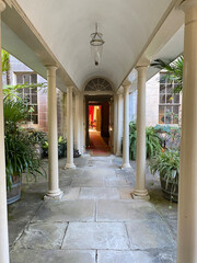 Entrance to a building with a covered roof supported by columns. Portico, hall and corridor in the...