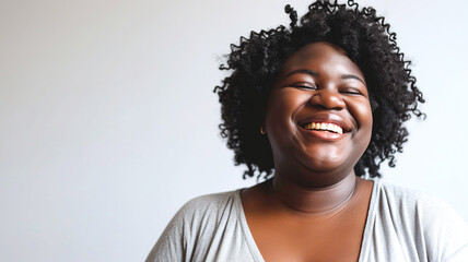 Young overweight woman smiling on a white background