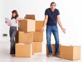 Young pair and many boxes in divorce settlement concept