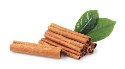 Aromatic cinnamon sticks and green leaves isolated on white