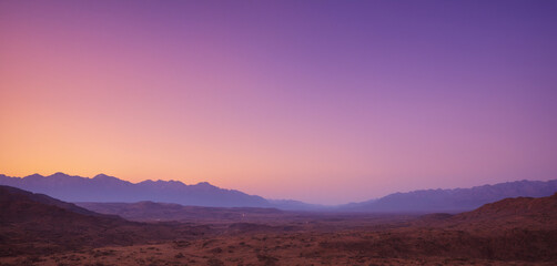 Mountain landscape purple sunset background.