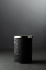 Black podium on a black background.