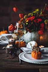 Fall table decoration with pumpkins, wine. Family cozy thanksgiving dinner arrangement indoors at home, wedding elegant decor. Countryside style, simple handmade setting, autumn mood, inspiration.