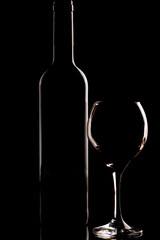 Wine and glass, a beautiful low key photo of a wine bottle and glass in silhouette, selective focus.