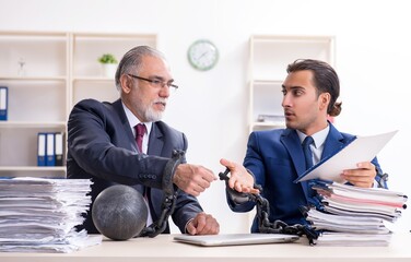Two male employees unhappy with excessive work