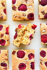 Blondies with raspberries and pecan nuts. White background. Top view