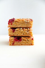 Blondies with raspberries and pecan nuts. White background. 