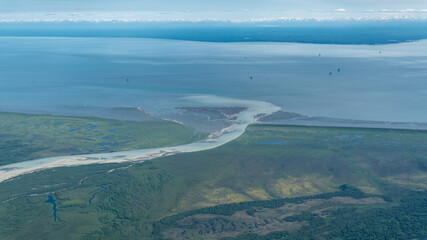 Oil Platforms in Cook Inlet basin, Middle Ground Shoal, Alaska. McArthur River with glacial sediment flows into Cook Inlet opposite of Nikiski on the Kenai Peninsula. 