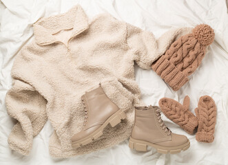 Trendy winter outfit on white background, top view