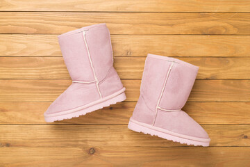 Suede boots on wooden background,top view