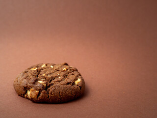 Chocolatey, rich cookies with contrasting white chocolate chips on a brown background. Cookies with white chocolate close-up.