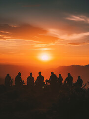 A Photo of a Group of People Watching the Sunset From a Hilltop
