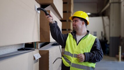 Video of young man with Down syndrome working in warehouse. Concept of workers with disabilities, support in workplace.