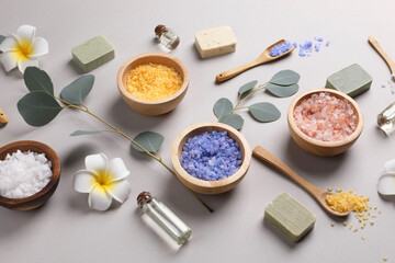 Composition with spa products and eucalyptus branches on grey background