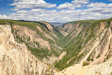 Grand Canyon of the Yellowstone River landscape with blue sky and white clouds in Yellowstone National Park Wyoming, USA.