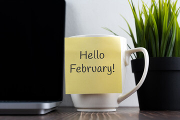 Hello February on adhesive note stick on coffee cup