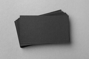 Blank black business cards on light background, top view. Mockup for design
