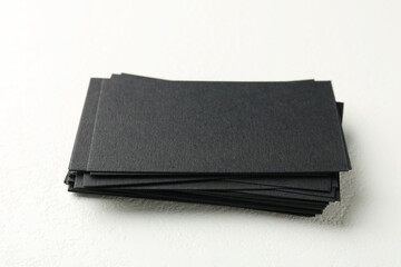 Blank black business cards on white table, closeup
