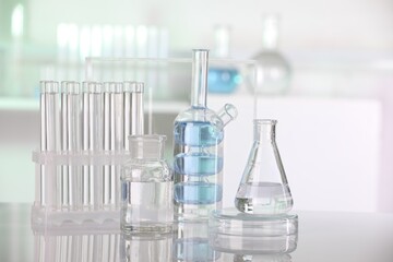 Laboratory analysis. Different glassware with liquid on white table indoors