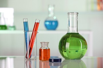 Laboratory analysis. Different glassware with liquids on white table indoors