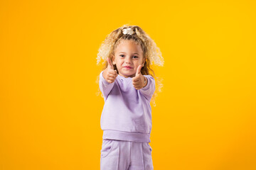 Child Girl Expressing Positivity with a Thumbs-Up Gesture ? Encouraging Success and Uplifting Vibes