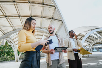 Young, multinational business team discuss financial and target groups to enhance profitability and...