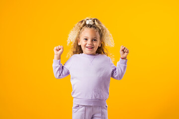 Child Girl Celebrating Victory with a Winning Gesture