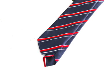 A close up of.a. red and navy tie on a white surface. 