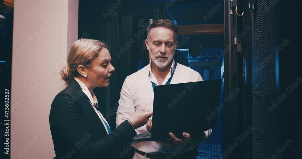 Poster Server room, man and woman or laptop with discussion, information technology and online workplace. Datacenter, people and collaboration with database to power computer hardware system and software