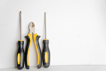 repair tool kit on white background, Pliers, screwdriver, adjustable wrench, adjustable wrench