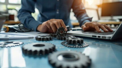 Maintenance engineer working on desk and pointing gears graphic signifies maintenance or inspection of machinery according to service intervals periods and corrective and preventive maintenance photog