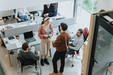 A team of colleagues are engaging in a collaborative discussion in a well-lit office environment,...