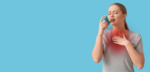 Young woman with inhaler feeling discomfort in chest on light blue background with space for text