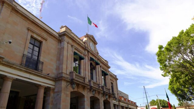 Tlalpan Municipal Palace buildign with Mexican flag waving in the historic center of Tlalpan, Mexico city, Mexico.