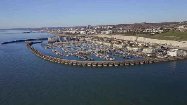 Brighton Marina in East Sussex, Southern England, aerial footage approaching the marina from the sea.