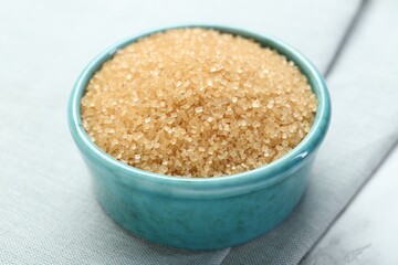 Brown sugar in bowl on table, closeup