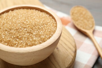 Brown sugar in bowl on table, closeup