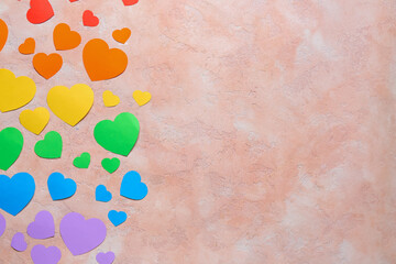Colorful paper hearts on grunge background. LGBTQ concept