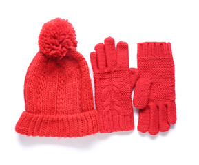 Red knitted gloves with warm hat on white background