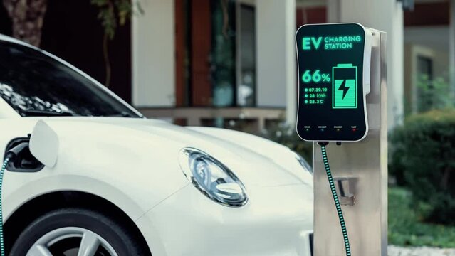 Electric car recharging from home charging station by futuristic EV charger. Cutting-edge technology advancement of EV car and smart home renewable energy infrastructure for sustainable power. Peruse