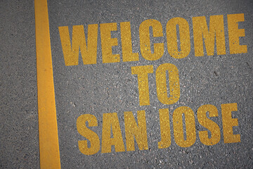 asphalt road with text welcome to san jose near yellow line.