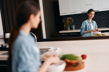 Female Friends Cooking Healthy Breakfast together in Beautiful Kitchen